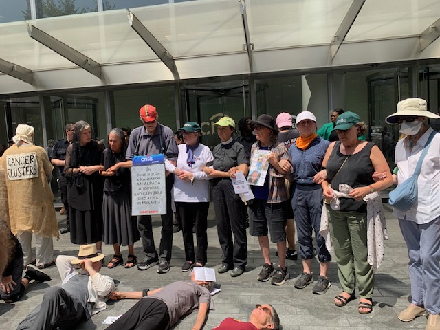 Activists outside Citigroup entrance stand around 3 lying on the floor as part of a “die-in”.