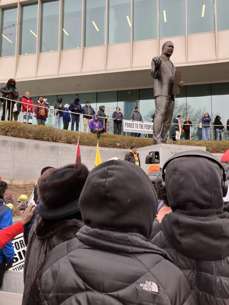 Marchers rally around the Martin Luther King statue in Newark, N.J. before the MLK March of Resistance on Jan. 18, 2025.