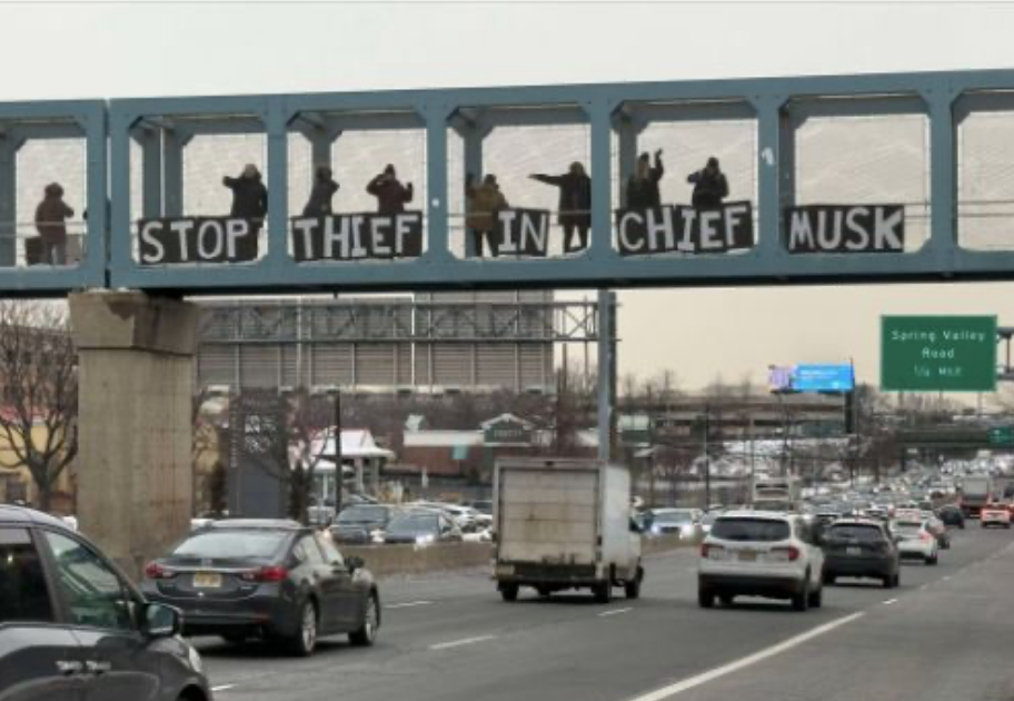 Paramus Visiblility Brigade on an earlier afternoon, with letter signs spelling out “Stop Thief in Chief Musk” (photo from their documentation).