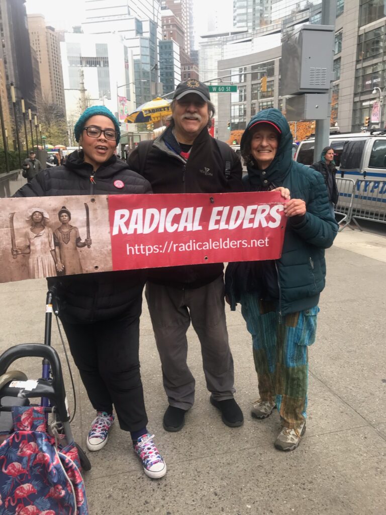 Radical Elders holding an RE banner